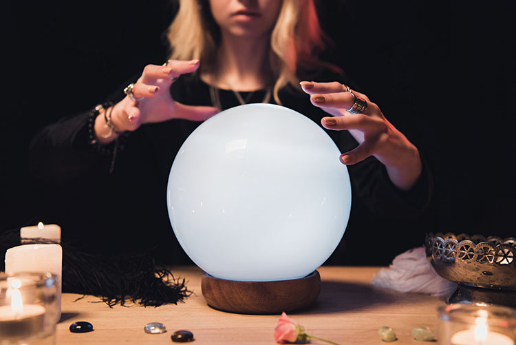 A psychic with a crystal ball, symbolizing common stereotypes about psychic readings.