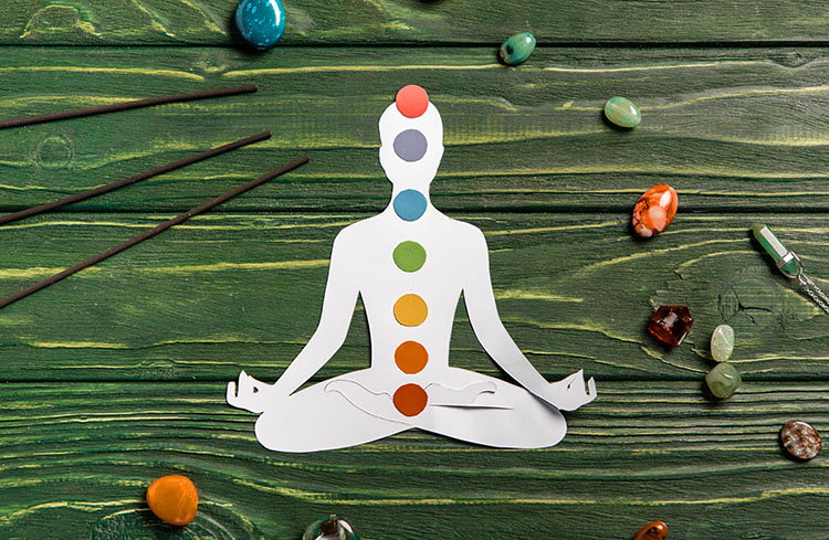 Chakra balancing illustration with meditative pose and healing crystals.